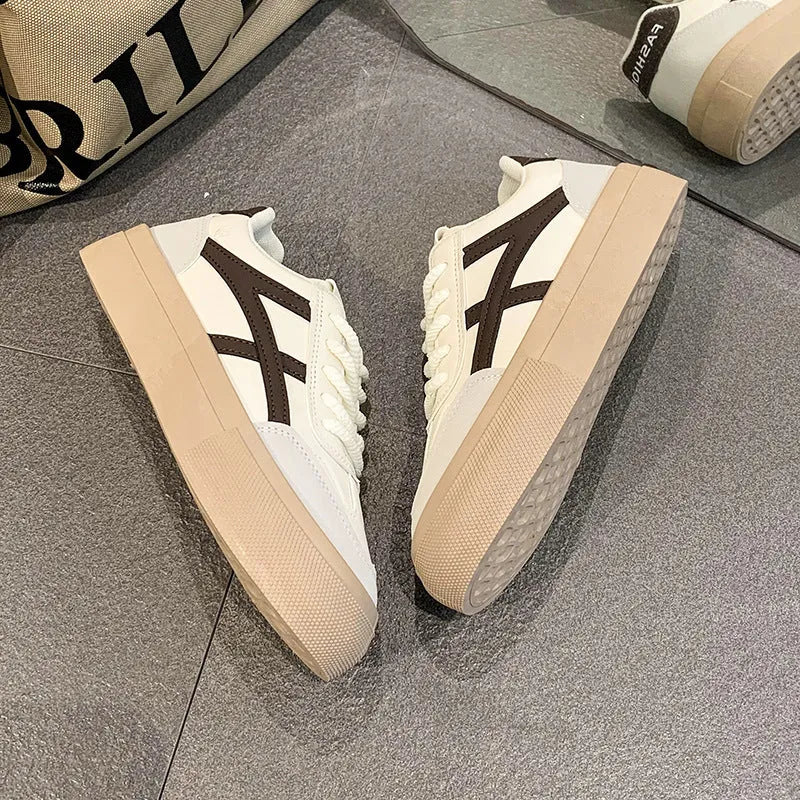 Low-top blue and brown casual lace-up shoes with round toe and flat rubber sole.