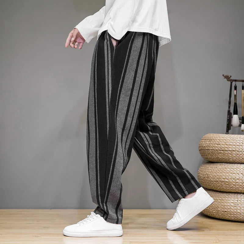 Navy blue and black striped men's casual trousers with a non-elastic waistband laid flat.