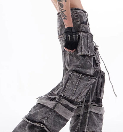 Grey distressed denim overalls jumpsuit with rope stitching on a hanger.