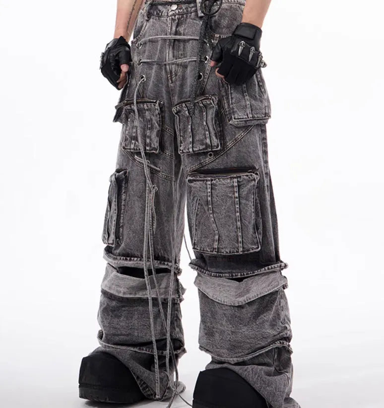 Grey distressed denim overalls jumpsuit with rope stitching on a hanger.