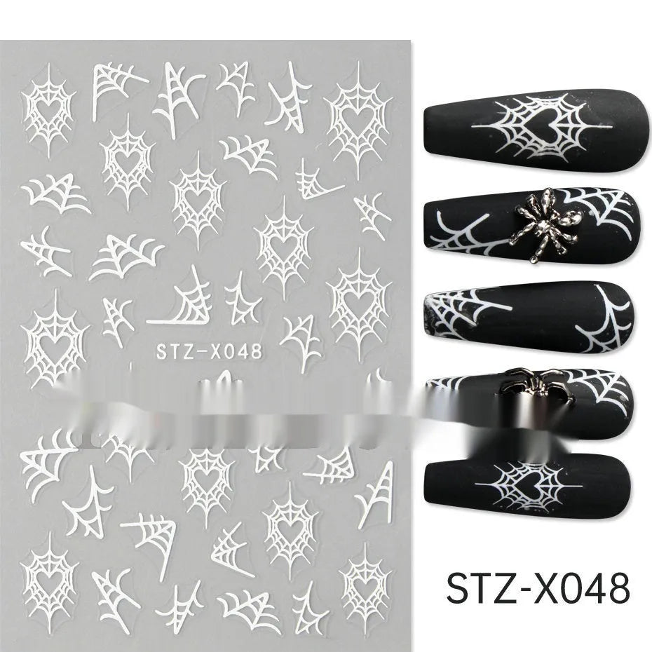 Assortment of black and silver nail sticker designs including cartoon and French tip patterns on a plastic sheet.