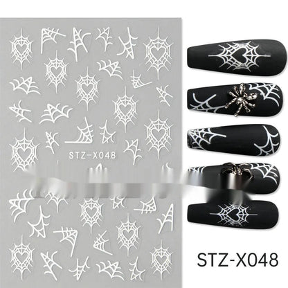 Assortment of black and silver nail sticker designs including cartoon and French tip patterns on a plastic sheet.