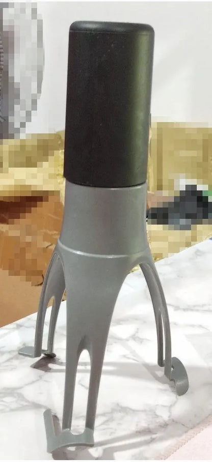 Uutensil Stirr automatic pot stirrer in grey placed inside a saucepan stirring sauce.
