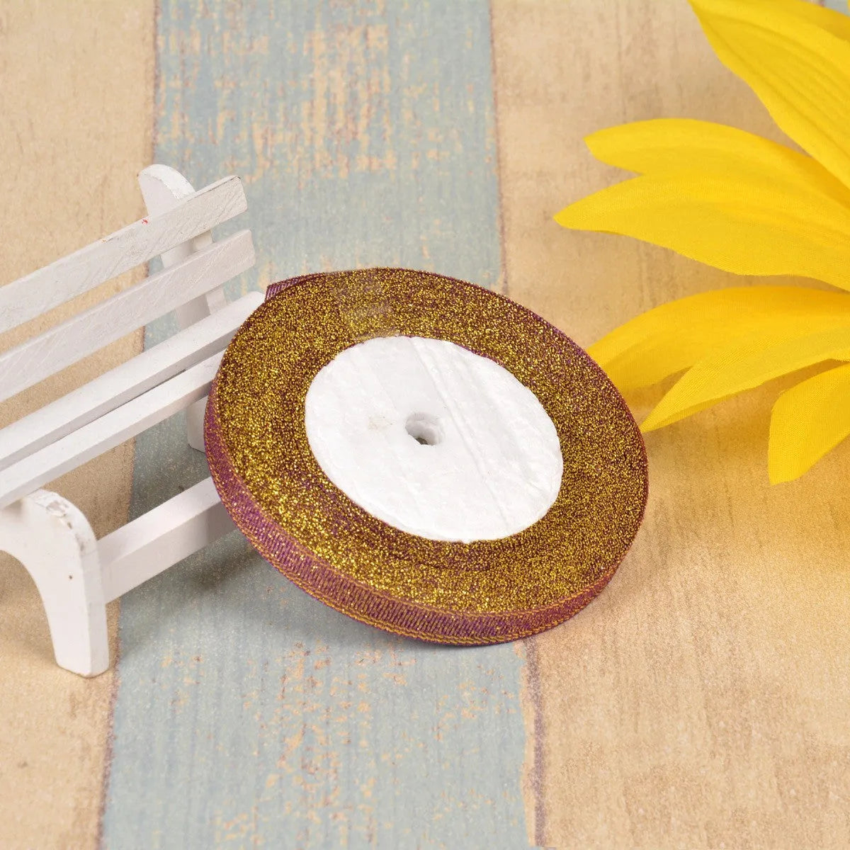 Close-up of green onion patterned ribbon with gold wire on a 25-yard roll, showing 3-points width.