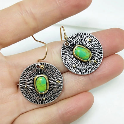 A pair of retro-style earrings with turquoise colour separation and an antique silver electroplated finish.