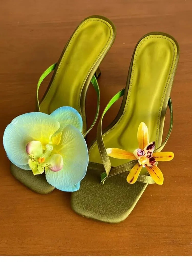 Women's handmade asymmetric flower high heel sandals in black, green, pink, or white on a calf leather upper with EVA sole.