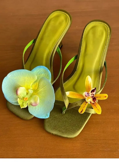 Women's handmade asymmetric flower high heel sandals in black, green, pink, or white on a calf leather upper with EVA sole.