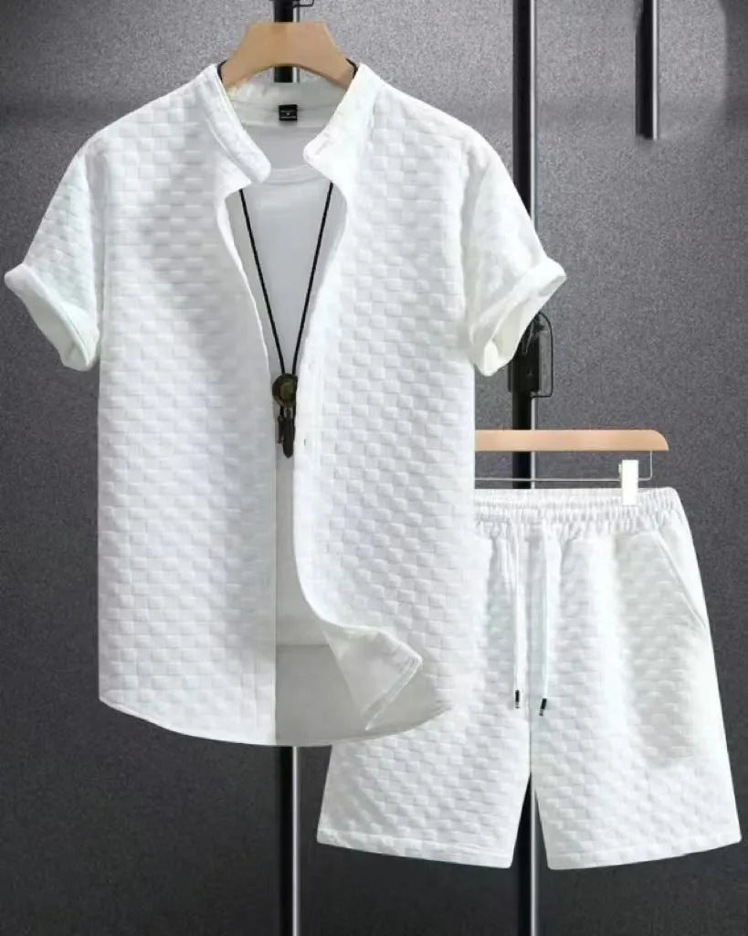 Man wearing a black and white jacquard short sleeve shirt and matching shorts suit set.