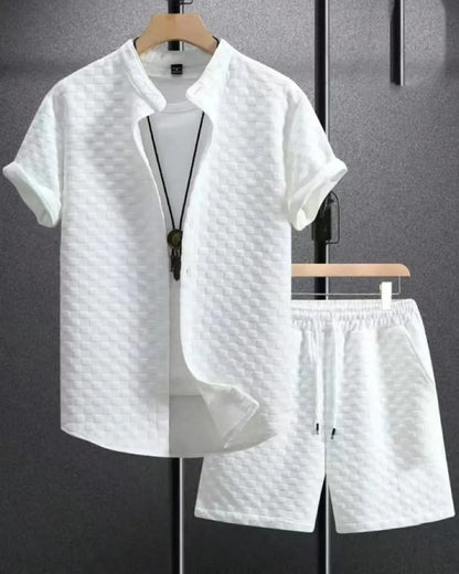 Man wearing a black and white jacquard short sleeve shirt and matching shorts suit set.