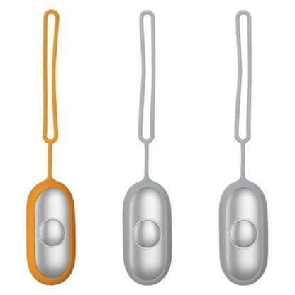Hand-held micro-current sleep aid device in grey, green, or orange with round button and USB charging port