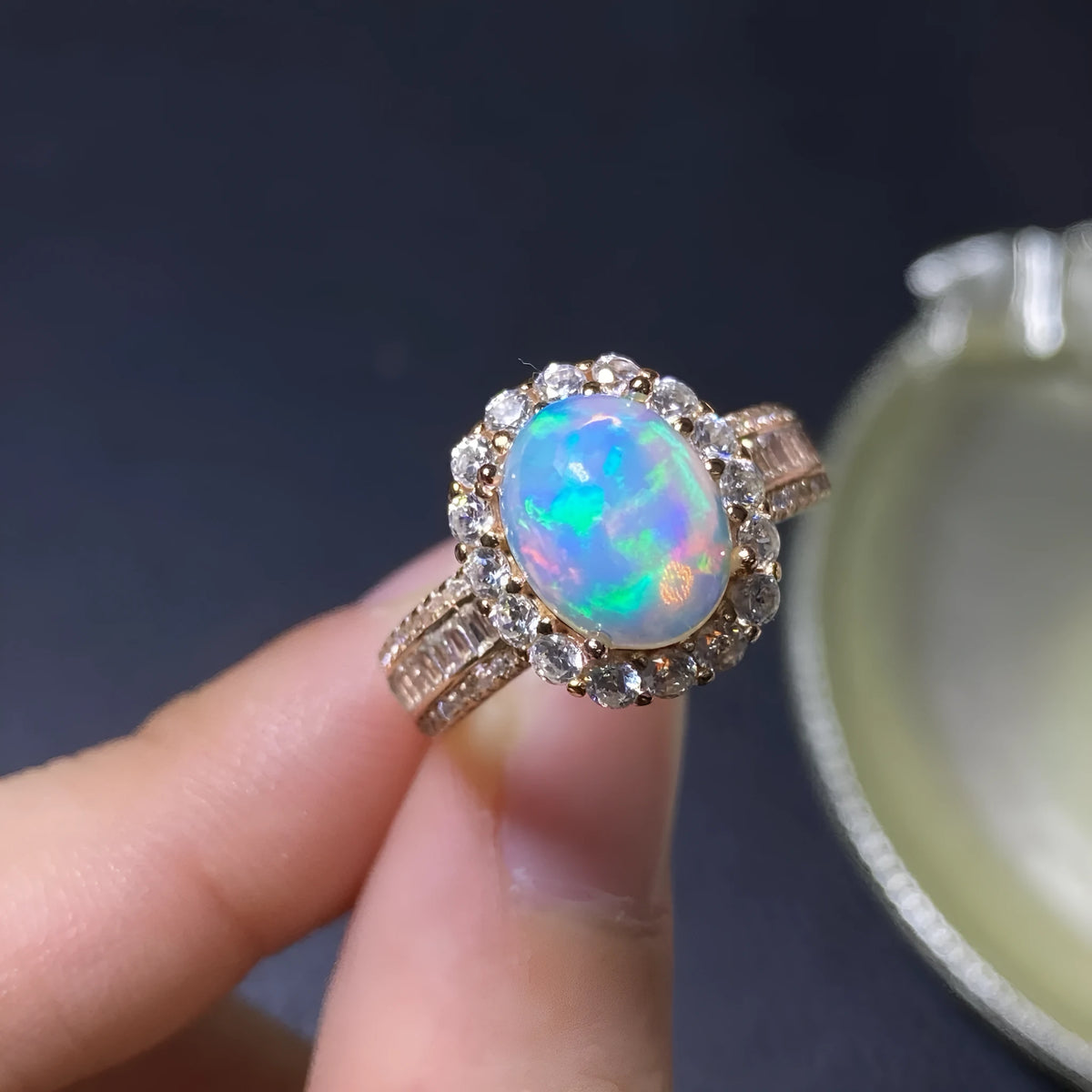 Handmade adjustable silver ring with a natural opal, shown in rose gold, yellow gold, and white gold plated finishes.