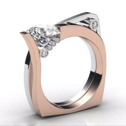 Rose gold geometry design women's ring with zircon stone centre, showing angular facets and electroplated finish