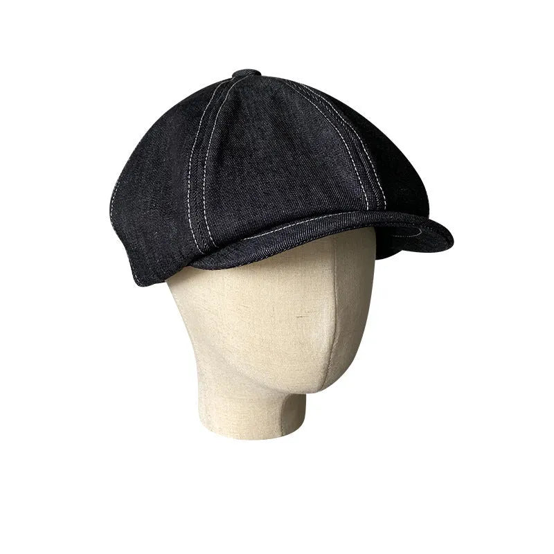 Black Japanese denim cotton beret hat showing octagonal cap style on neutral background