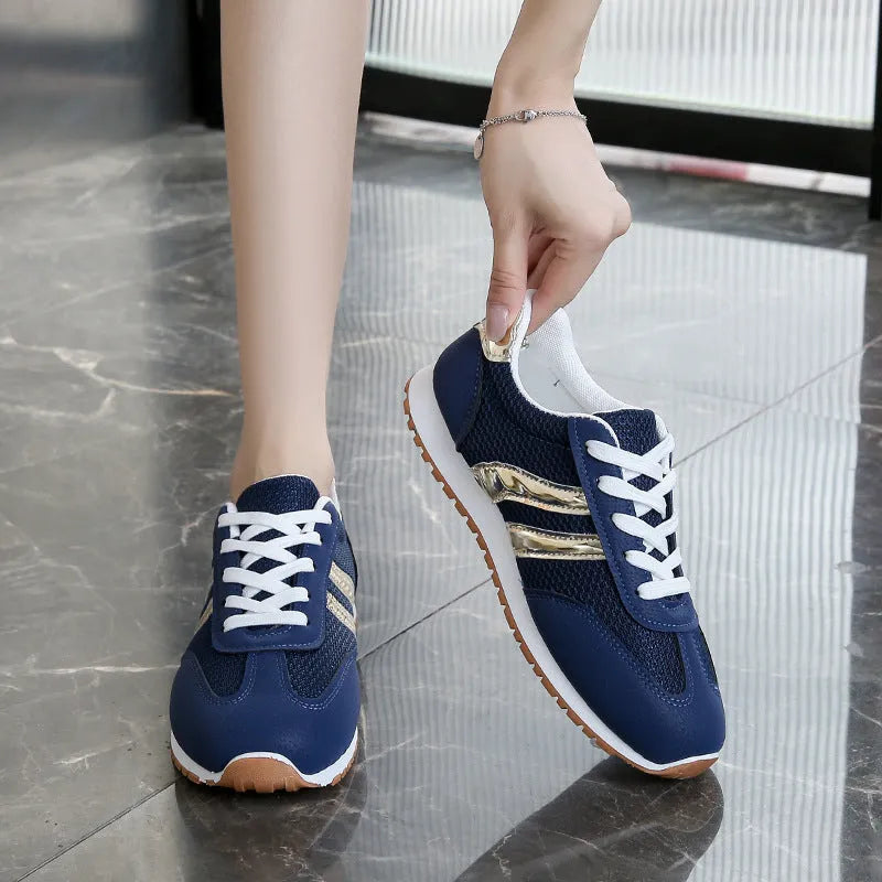 Blue women's casual sports shoes with cross shoulder straps and a round toe, featuring a flat heel and lace-up front.