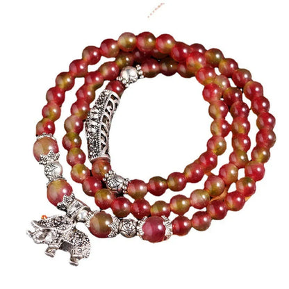 Handmade bracelet with green and pink watermelon crystal beads tied with Chinese knots.