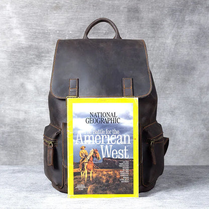 Retro brown genuine cowhide leather backpack with shoulder straps and a top handle.