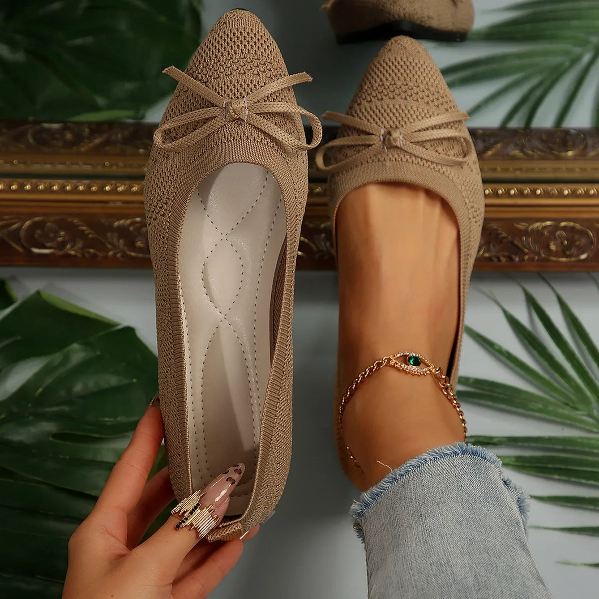 Women's blue knitted loafer flat shoes with a pointed toe and decorative bow detail on the front.