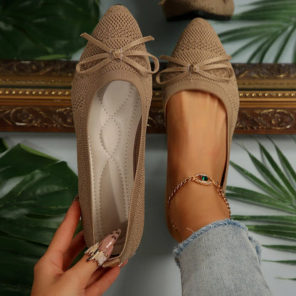 Women's blue knitted loafer flat shoes with a pointed toe and decorative bow detail on the front.