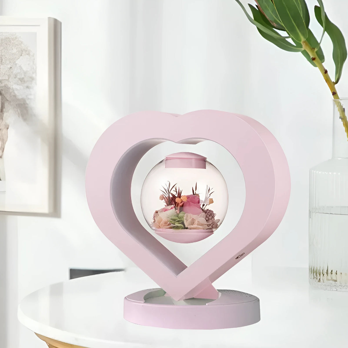 Pink preserved rose ornament with Bluetooth speaker and LED light on wooden table