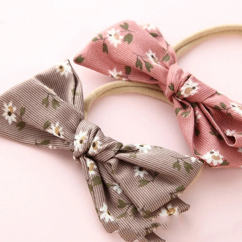 Children's cloth hair band with knotted bow design in one of six colour options