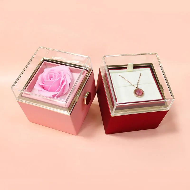 Rotating rose jewellery gift box with a preserved red rose under a clear acrylic dome, showing the interior rotating drawer.