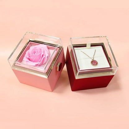Rotating rose jewellery gift box with a preserved red rose under a clear acrylic dome, showing the interior rotating drawer.