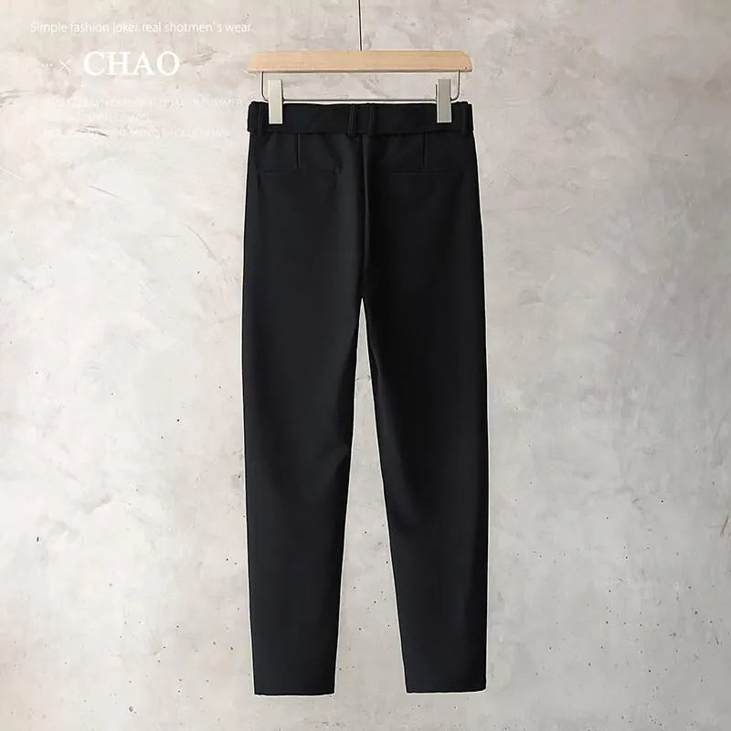 Boys slim straight wool trousers in tapered fit on hanger, showing straight leg opening.