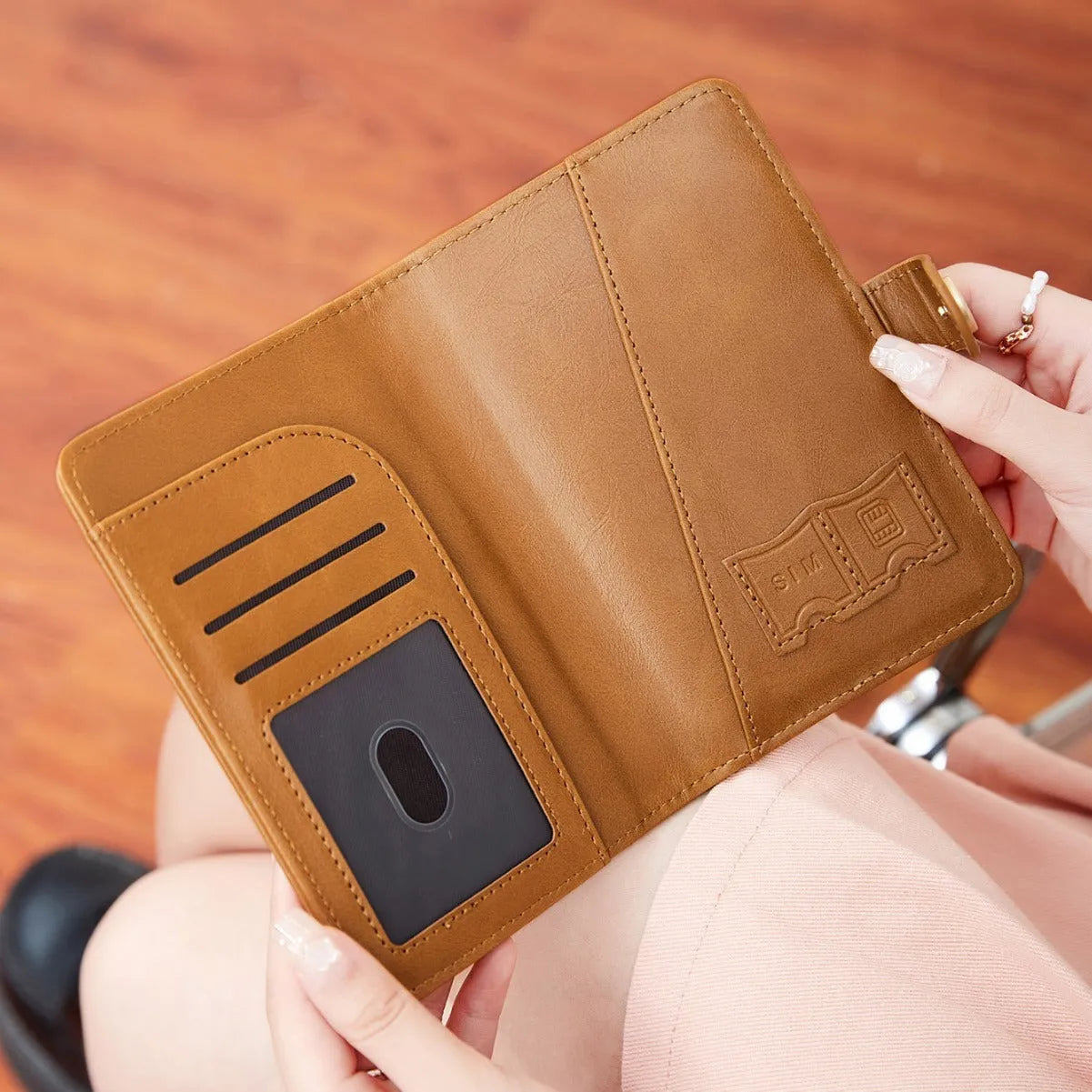 PU passport wallet with sewing line detail, shown in multiple colours including black, pink, and blue, featuring anti-theft swiping protection.