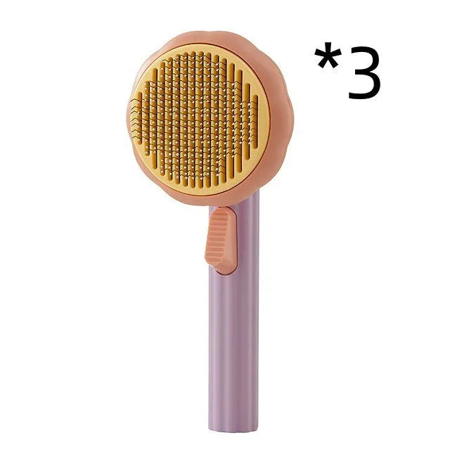 Hand-held pumpkin-coloured pet brush with stainless steel needles for grooming cats and dogs