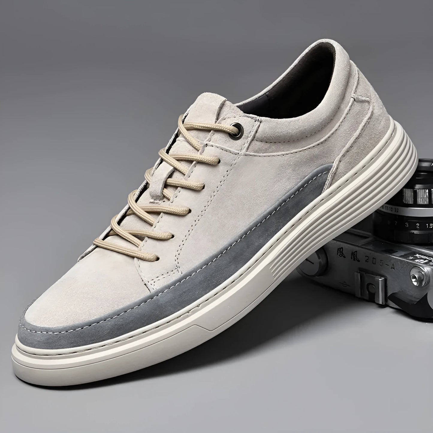 Men's grey low-top casual leather skate shoes with round toe and flat rubber sole on a neutral background.