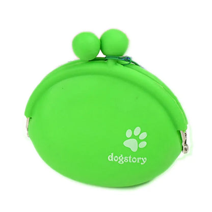 Yellow silicone dog training treat pouch with hook and loop closure, shown on a waistband.