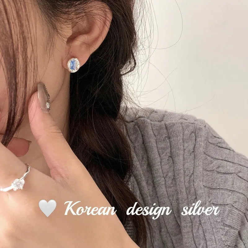 Women's S925 sterling silver oval blue diamond heart-wrapped earrings with electroplated silver finish