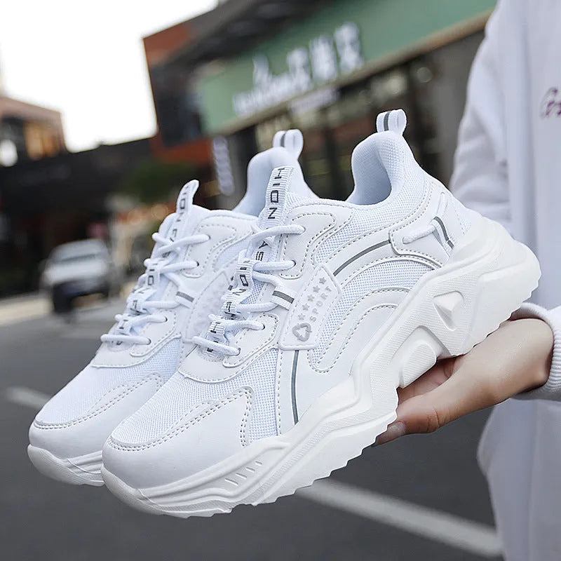 White women's thick-soled casual sports shoes with mesh upper, round toe, and buckle detail.