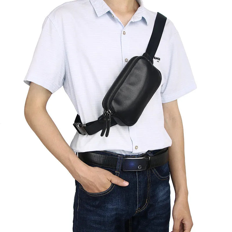 Men's small leather crossbody bag in black showing compact dimensions and crossbody strap