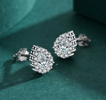 A pair of drop-shaped sterling silver ear studs with a diamond-cut finish.