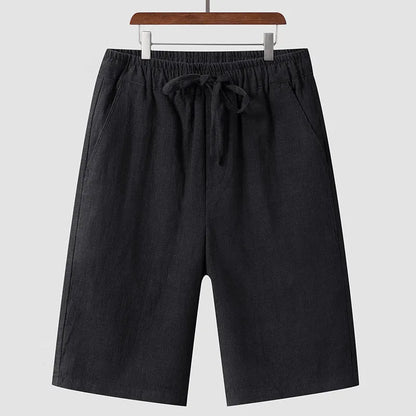 Men's beige linen casual shorts with a loose fit and elastic waistband on a neutral background.