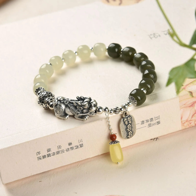Women's coin bracelet crafted in sterling silver featuring genuine Hetian jade beads measuring 8x7mm, designed with a retro style for a natural and classic jewellery look suitable for everyday wear or special occasions.