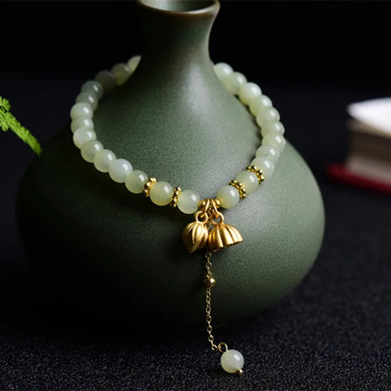 Natural Hetian jade bracelet with 6mm beads, engraved fu character, and constellation design on a simple string.