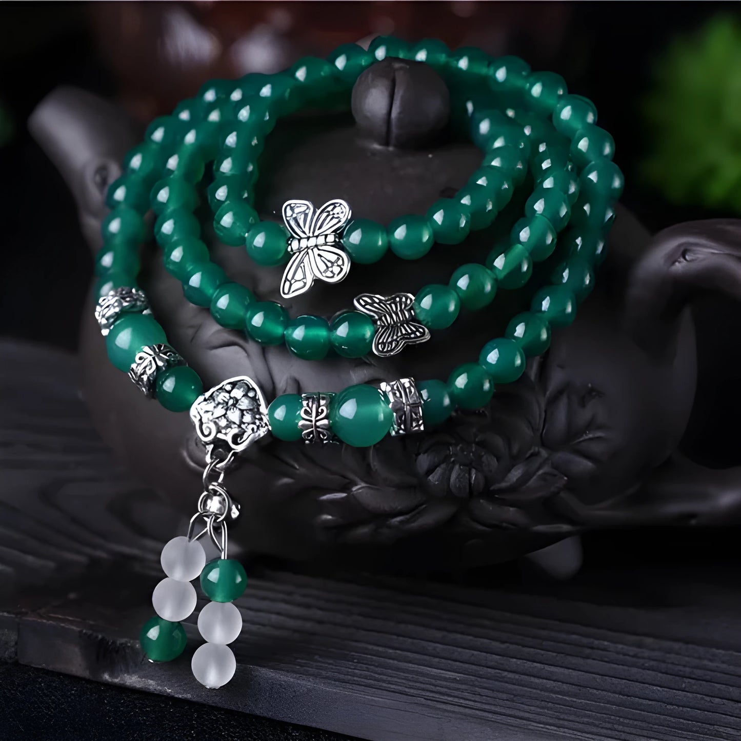 Close-up of a green agate multi-layer chain bracelet with three strands of 6mm beads.