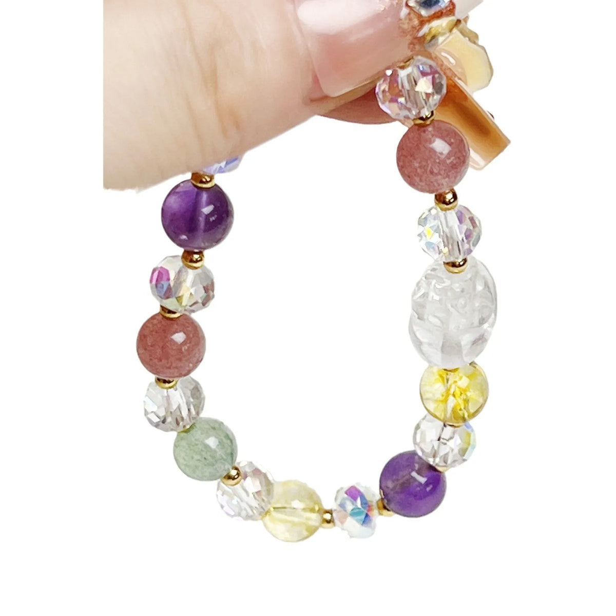 Close-up of a handmade crystal bracelet with a detailed nine-tailed fox design on a wrist.