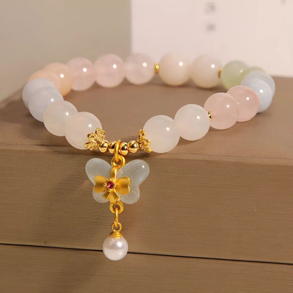 Original design women's bracelet with colourful morganite butterfly pendant made from crystal and jade.