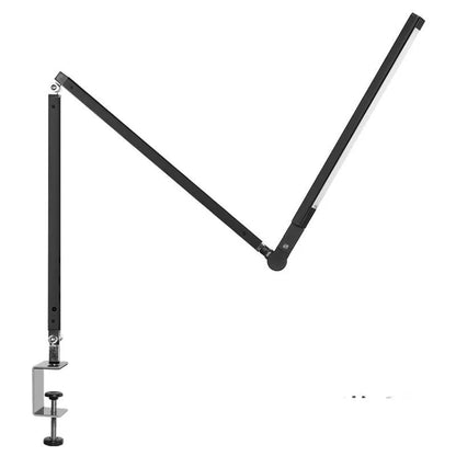 Adjustable aluminium desk lamp with remote control, shown in black with a clip attached to a desk edge.