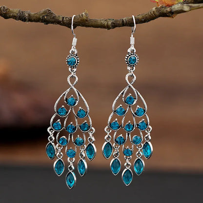 Purple drop-shaped alloy earrings with long fringe and crystal details on a retro style.