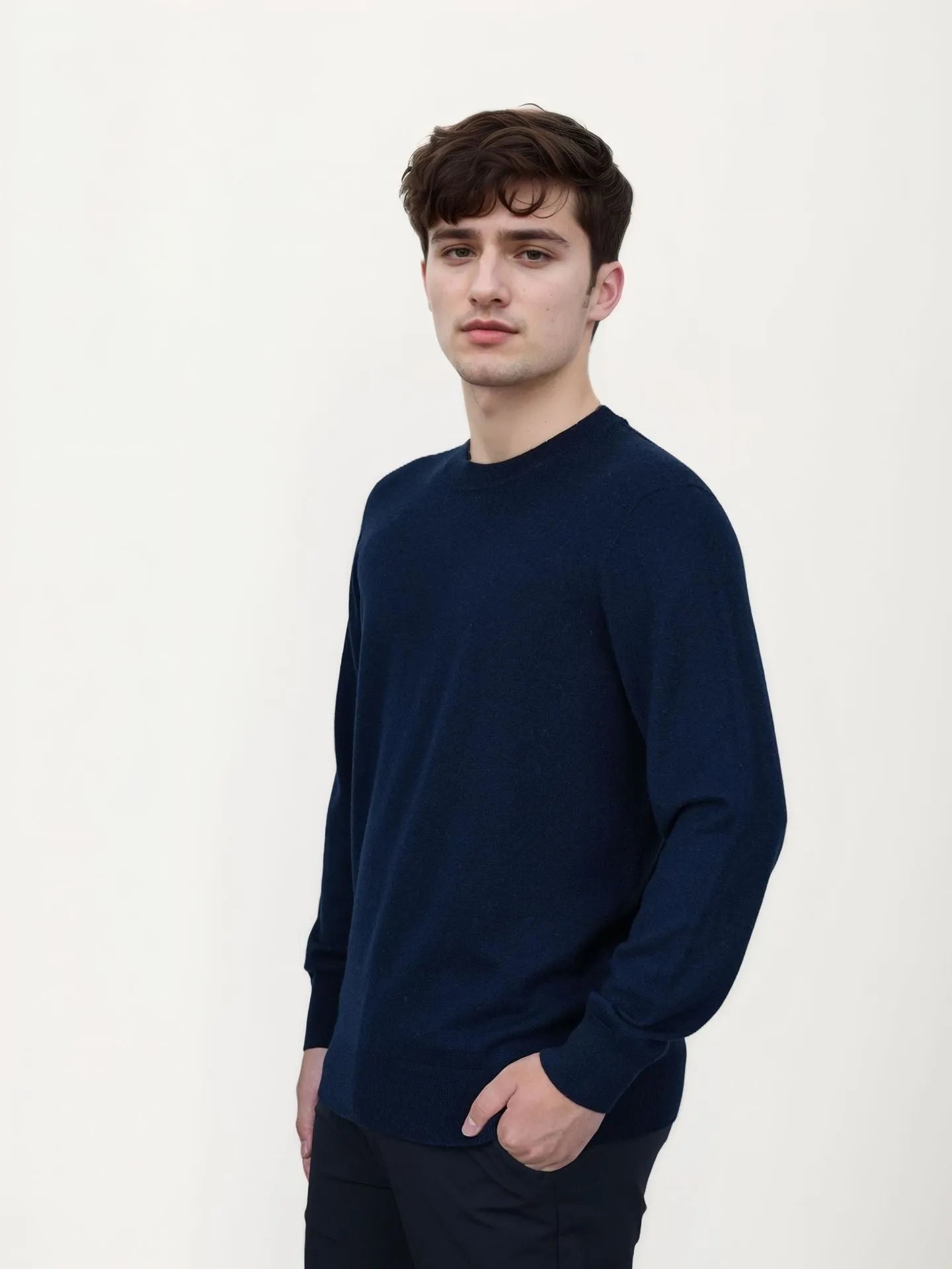 Men's V-neck wool pullover sweater in light grey shown on a model.