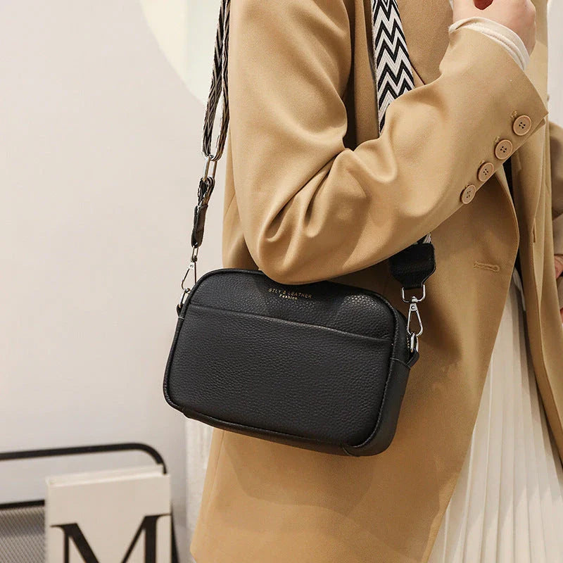 Stylish crossbody bag with rhombus embroidery, wide adjustable shoulder strap, and multiple interior pockets in various color options