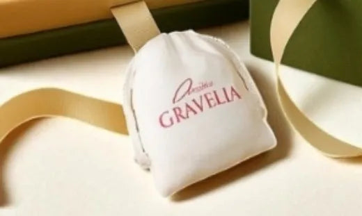 Small cloth drawstring jewellery bag made from textile flocking with heat transfer printed design for gift presentation and jewellery storage measuring 12 x 15 cm in white colour