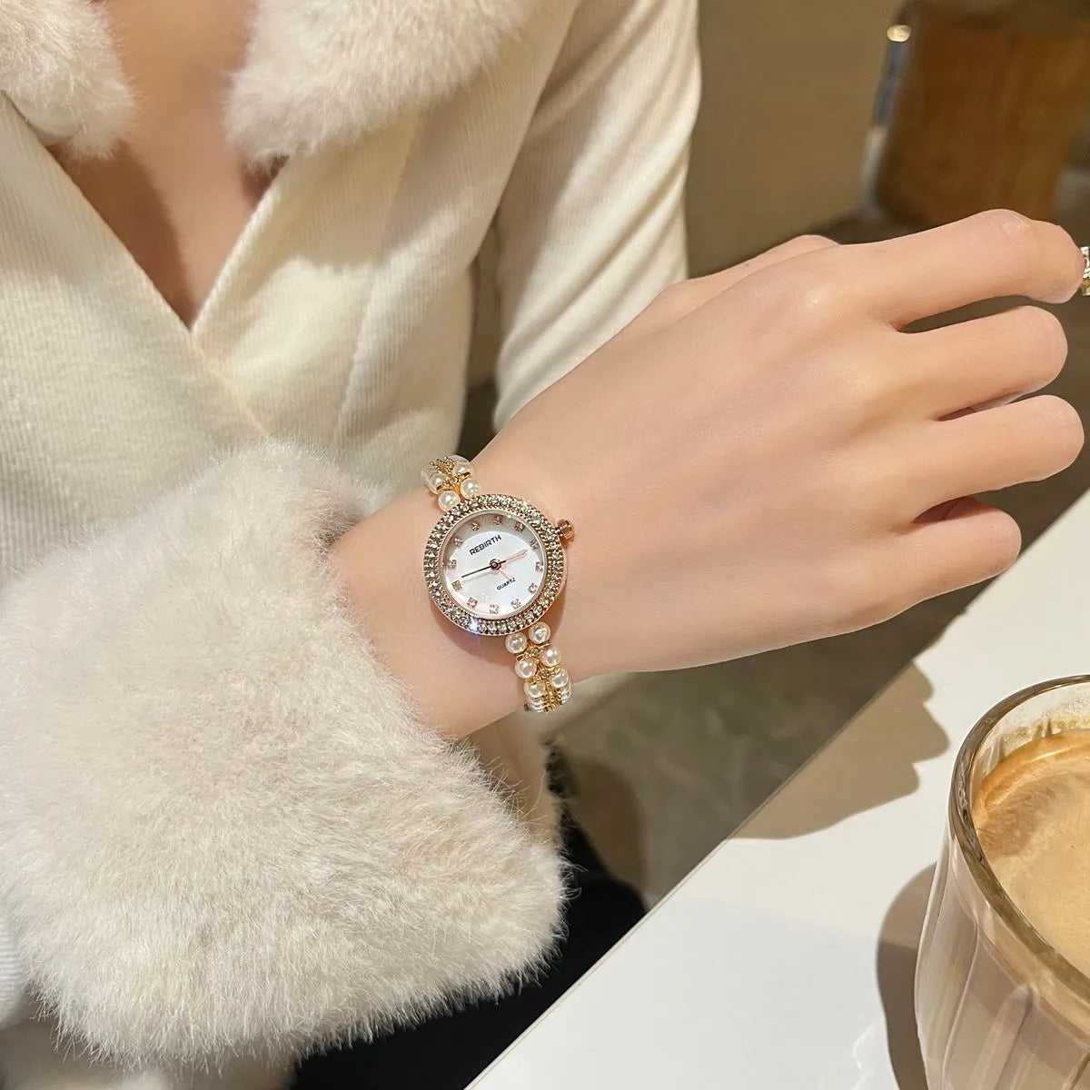 Women's vintage freshwater pearl bracelet watch with 25mm dial, steel strap, and double row pearl design in silver