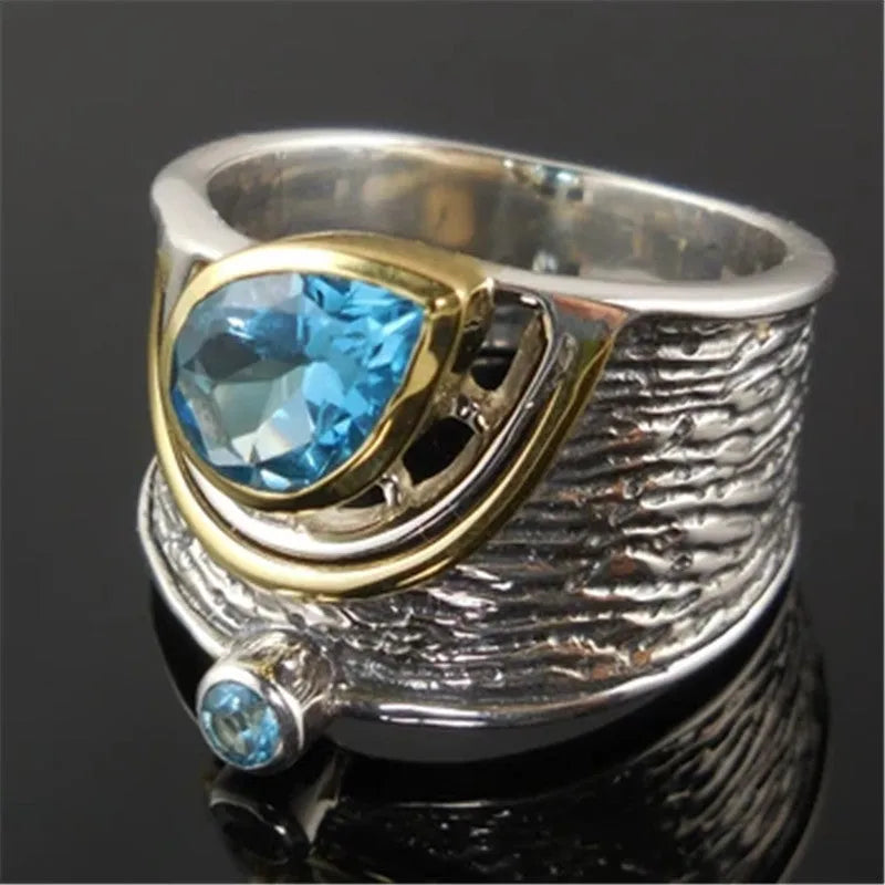 Creative Chinese style women's ring with an inlaid blue zircon stone in a drop shape on an alloy band.
