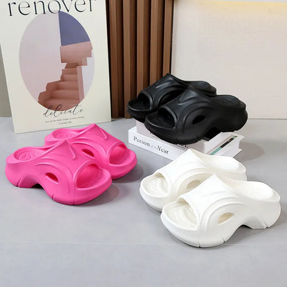 Women's white thick-soled EVA slippers with a round toe on a beach background.