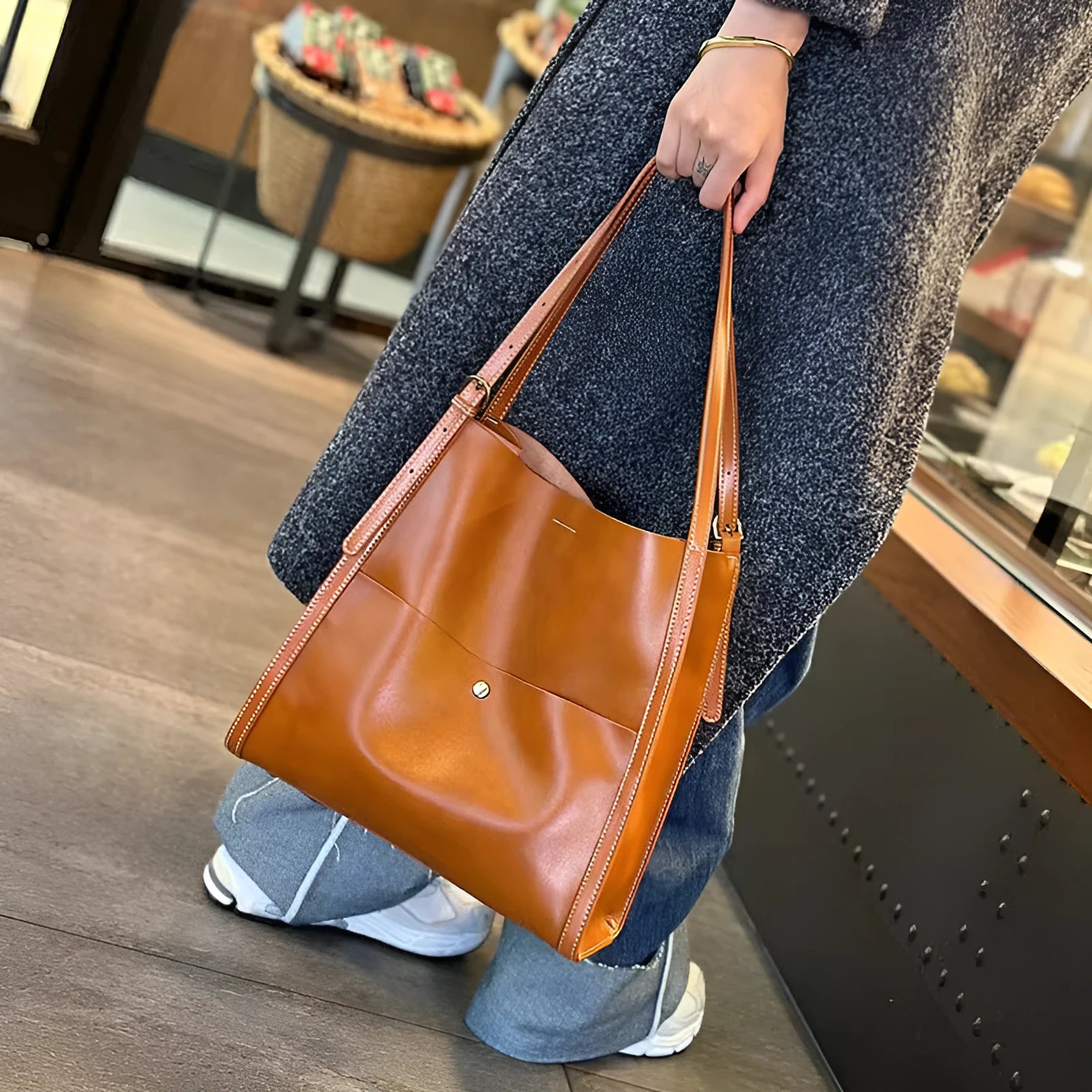 Genuine leather women's tote bag in a square shape with multiple internal pockets, shown in sunset yellow.